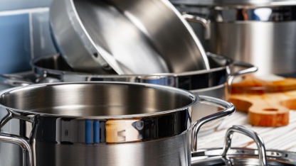 Set of aluminum cookware on kitchen counter