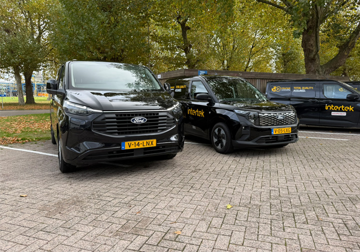 Three black vans with yellow Intertek branding. 