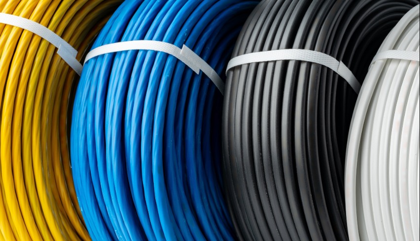 A Close-Up Photo of Four Spools of Electrical Wire, Each Wound in a Different Color.