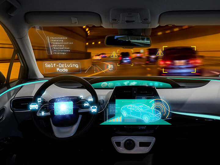 View of dashboard and windshield of the concept of autonomous self driving car going through a tunnel