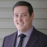 A professional headshot of Heil John