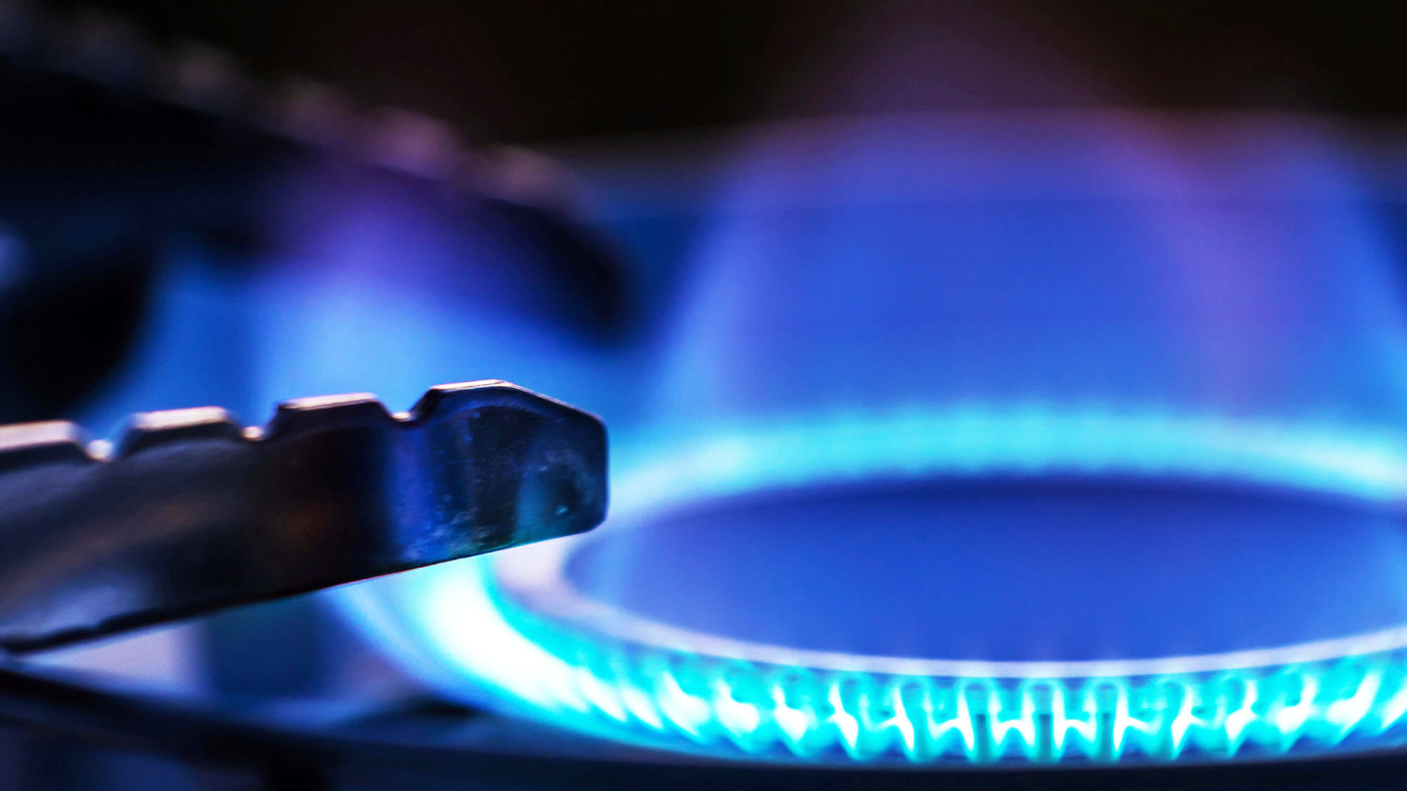 Close up view of gas stove with blue flame