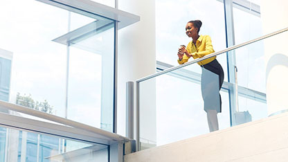 Woman on walkway in glass building