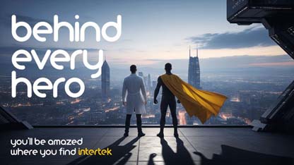 A man in a laboratory coat standing next to a superhero character at the top of a tall building overlooking a metropolis